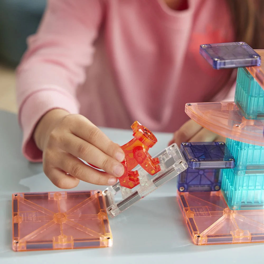 Child playing with transparent building blocks on a light surface